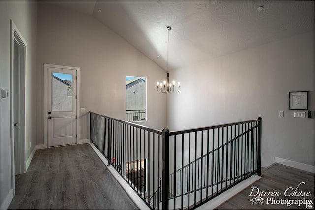 1460 S Windsor Pkwy Unit 5, Hurricane, UT 84737 - staircase featuring baseboards, high vaulted ceiling, wood finished floors, and a notable chandelier