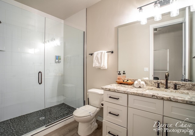1460 S Windsor Pkwy Unit 5, Hurricane, UT 84737 - bathroom with wood finished floors, a shower stall, toilet, and vanity