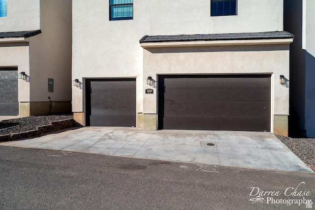 1460 S Windsor Pkwy Unit 5, Hurricane, UT 84737 - view of front facade with concrete driveway, a garage, and stucco siding