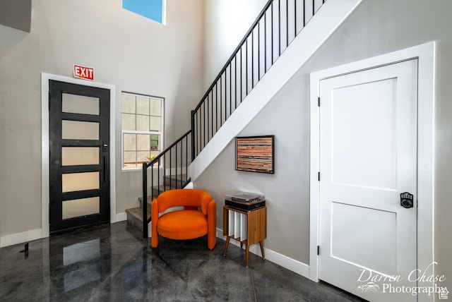 1460 S Windsor Pkwy Unit 5, Hurricane, UT 84737 - foyer entrance with finished concrete flooring, a high ceiling, stairs, and baseboards