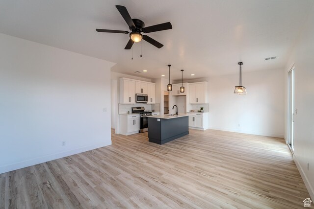 3377 W Palomar, Hurricane, UT 84737 - kitchen featuring visible vents, open floor plan, appliances with stainless steel finishes, white cabinetry, and a kitchen island with sink