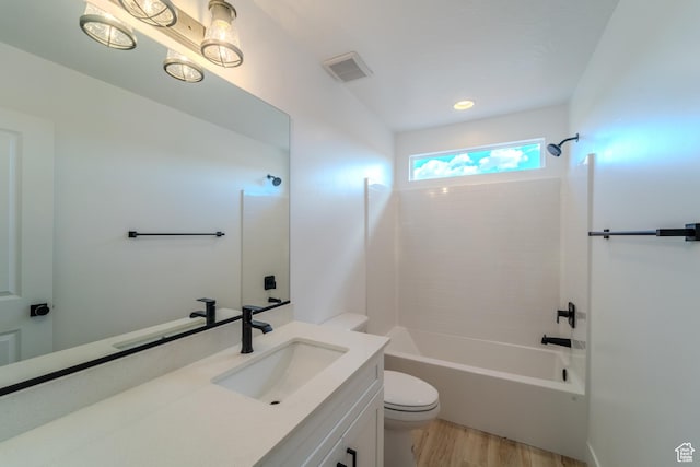 3377 W Palomar, Hurricane, UT 84737 - full bathroom featuring visible vents, toilet, vanity, wood finished floors, and washtub / shower combination