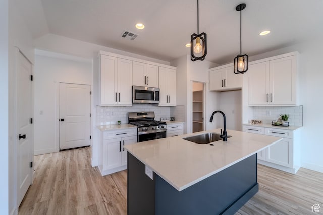 3377 W Palomar, Hurricane, UT 84737 - kitchen with visible vents, light wood finished floors, a sink, stainless steel appliances, and white cabinetry