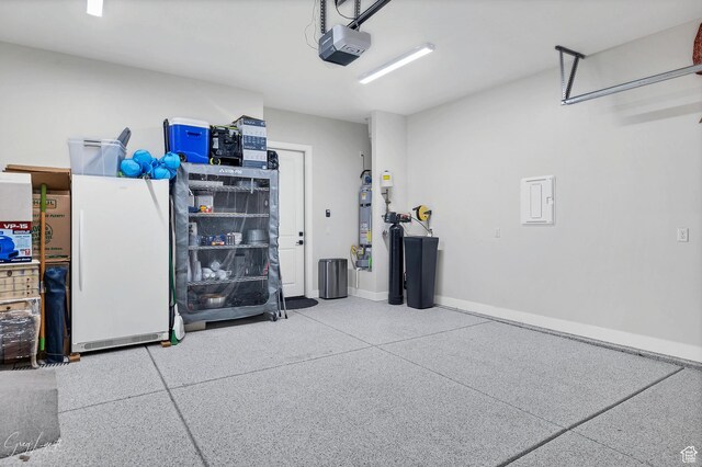 4755 S Purcell Dr, St George, UT 84790 - garage featuring baseboards, a garage door opener, and freestanding refrigerator