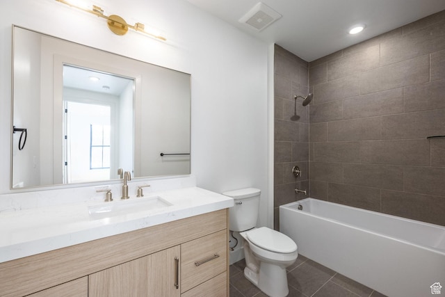 bathroom with vanity, visible vents, tile patterned flooring, shower / tub combination, and toilet