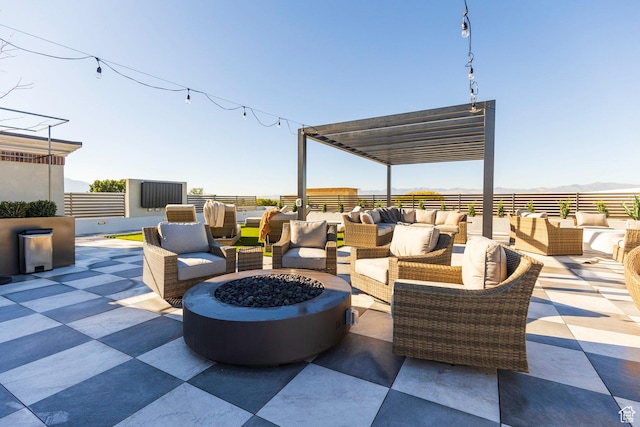 view of patio with an outdoor living space with a fire pit
