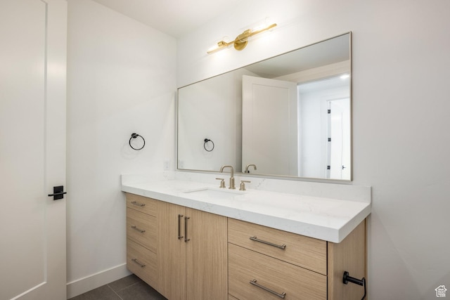 bathroom featuring tile patterned floors, baseboards, and vanity