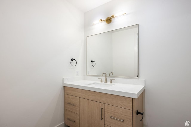 bathroom with vanity and baseboards