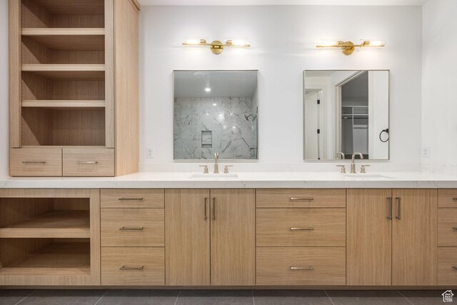 bathroom with double vanity, tile patterned flooring, built in shelves, and a sink