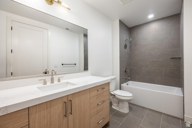 bathroom with tile patterned floors, shower / bathing tub combination, toilet, and vanity