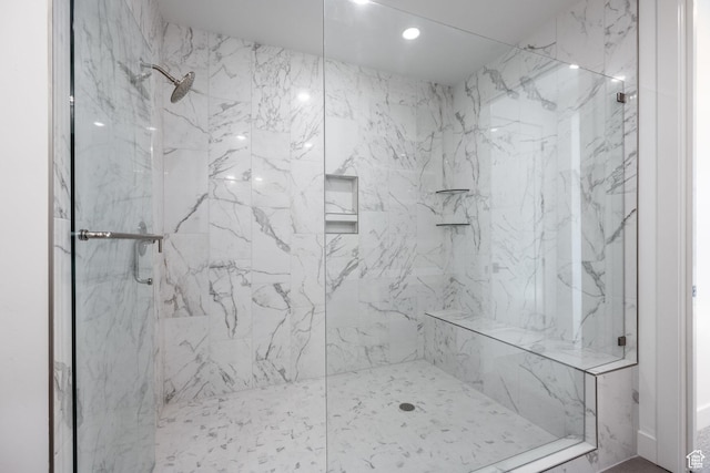 full bath featuring a marble finish shower