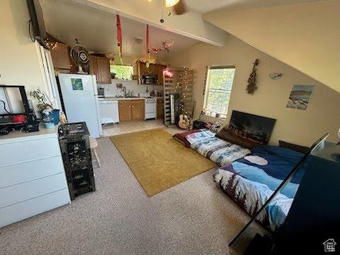 14028 S Candy Pull Dr, Draper, UT 84020 - living area featuring a ceiling fan and vaulted ceiling with beams