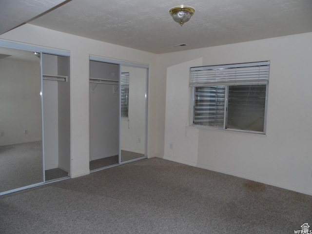 14028 S Candy Pull Dr, Draper, UT 84020 - unfurnished bedroom with visible vents, two closets, carpet, and a textured ceiling