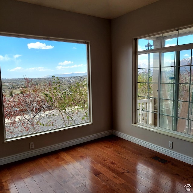 14028 S Candy Pull Dr, Draper, UT 84020 - spare room featuring baseboards, visible vents, a mountain view, and wood-type flooring