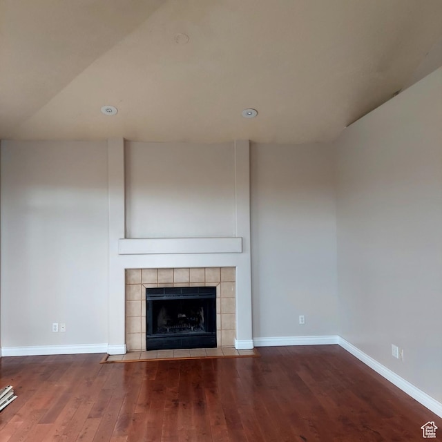 14028 S Candy Pull Dr, Draper, UT 84020 - unfurnished living room featuring baseboards, a tiled fireplace, and wood finished floors