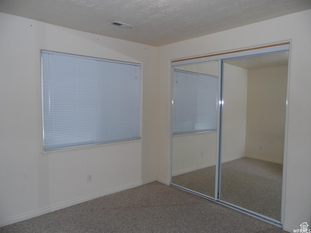 14028 S Candy Pull Dr, Draper, UT 84020 - unfurnished bedroom featuring a closet, a textured ceiling, visible vents, carpet, and baseboards