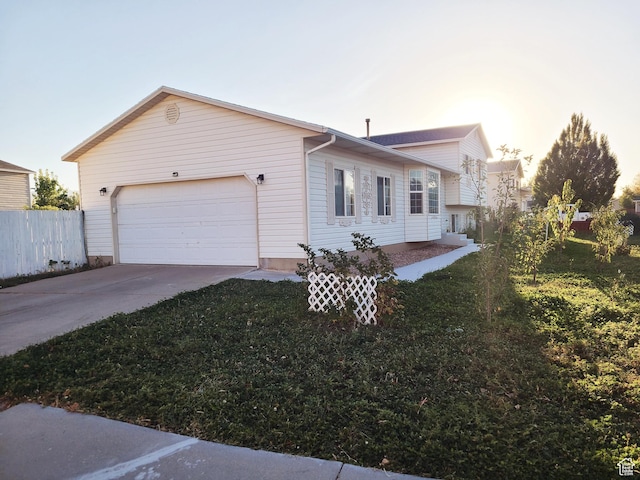 exterior space with a garage, driveway, and fence