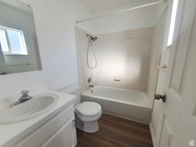 bathroom with wood finished floors, shower / bathtub combination, vanity, and toilet