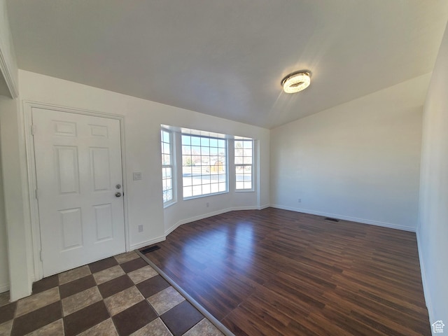 foyer with visible vents, baseboards, and dark wood-style flooring