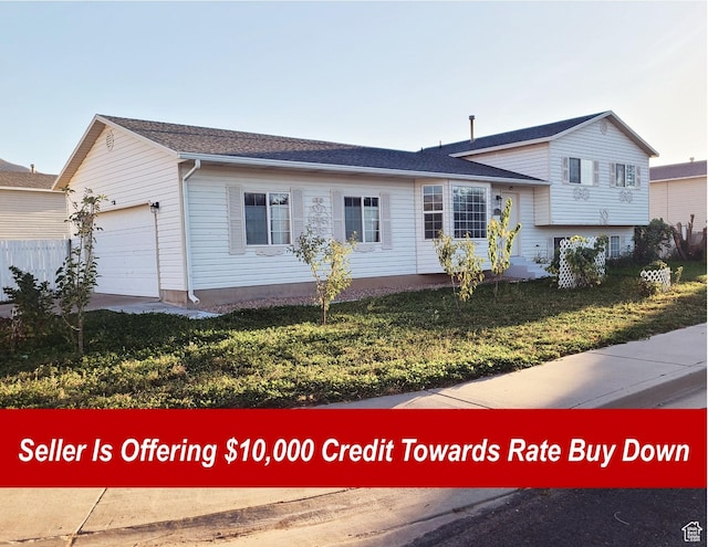 split level home with a garage and a front yard