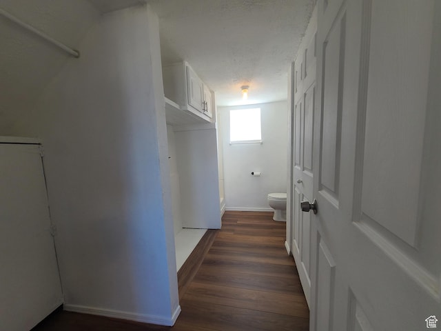 bathroom featuring wood finished floors, toilet, and baseboards