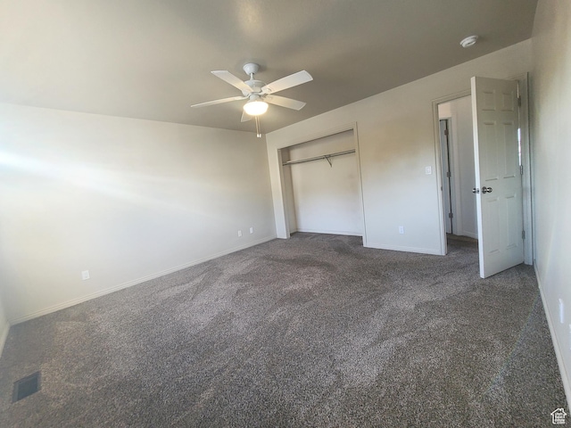 unfurnished bedroom featuring visible vents, baseboards, carpet flooring, and a closet