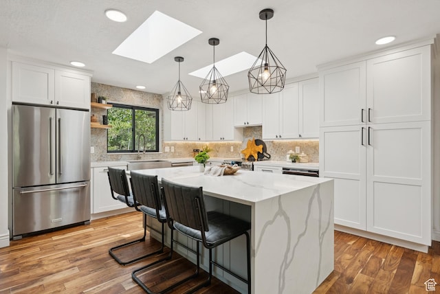3041 Homestead Rd, Park City, UT 84098 - kitchen featuring high quality fridge, a skylight, light wood-type flooring, white cabinetry, and recessed lighting