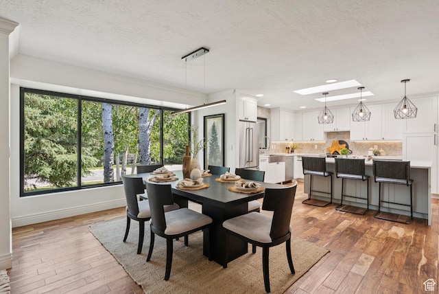 3041 Homestead Rd, Park City, UT 84098 - dining area with light wood-style floors, a textured ceiling, and recessed lighting