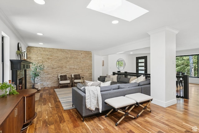 3041 Homestead Rd, Park City, UT 84098 - living room with light wood finished floors, recessed lighting, a skylight, ornamental molding, and a fireplace