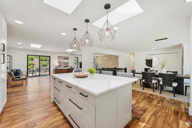 3041 Homestead Rd, Park City, UT 84098 - kitchen with a skylight, open floor plan, recessed lighting, white cabinets, and light wood-type flooring