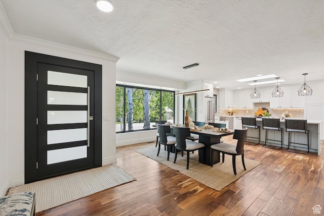 3041 Homestead Rd, Park City, UT 84098 - dining space featuring a textured ceiling, light wood-style floors, ornamental molding, and recessed lighting