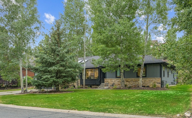 3041 Homestead Rd, Park City, UT 84098 - view of front of house with stone siding, a front yard, and a shingled roof