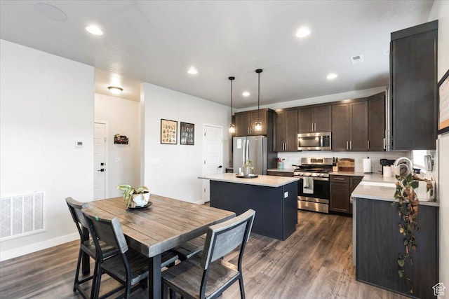 dining space with baseboards, dark wood-style floors, visible vents, and recessed lighting