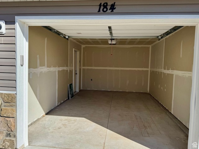 184 W Seasons Ln Unit 56, Garden City, UT 84028 - garage with driveway and a garage door opener