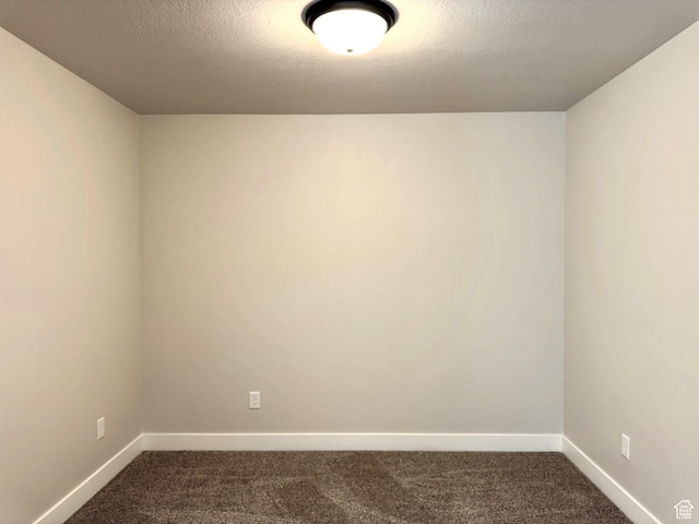 184 W Seasons Ln Unit 56, Garden City, UT 84028 - spare room featuring baseboards, dark carpet, and a textured ceiling