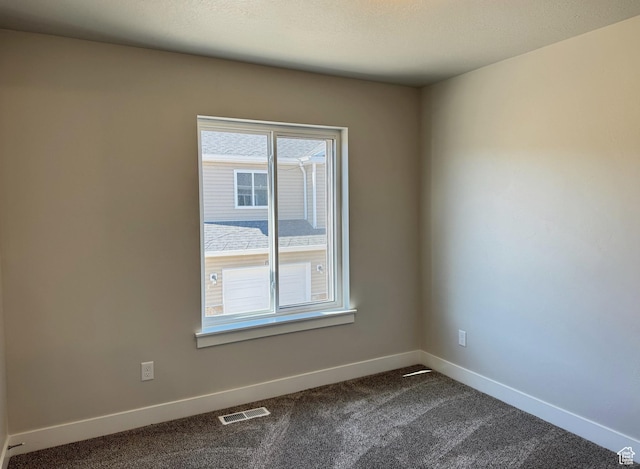 184 W Seasons Ln Unit 56, Garden City, UT 84028 - empty room with baseboards, dark carpet, and visible vents