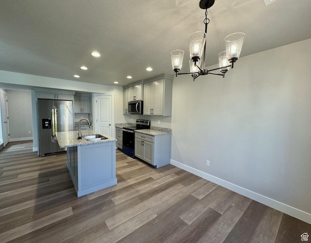 184 W Seasons Ln Unit 56, Garden City, UT 84028 - kitchen with baseboards, a sink, wood finished floors, and appliances with stainless steel finishes