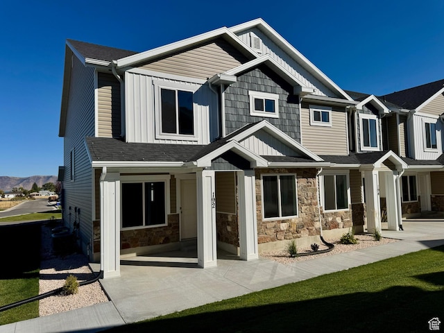 192 W Seasons Ln Unit 52, Garden City, UT 84028 - view of front of property with stone siding, a mountain view, and board and batten siding