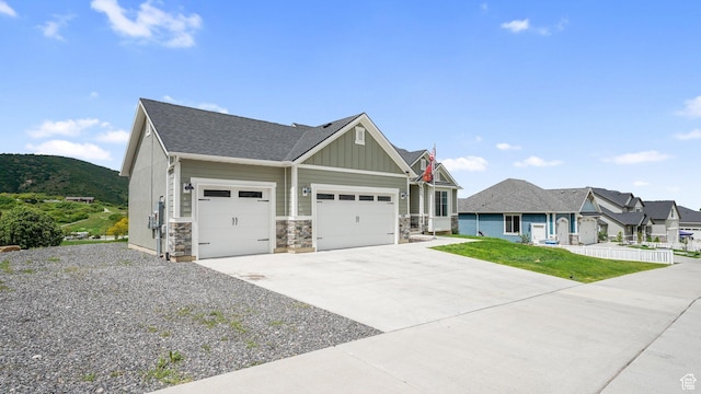 209 N Elk Ridge Dr, Elk Ridge, UT 84651 - craftsman inspired home featuring a garage, board and batten siding, concrete driveway, and stone siding