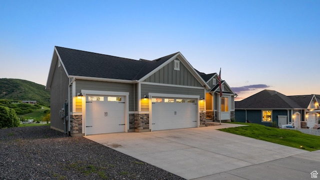 209 N Elk Ridge Dr, Elk Ridge, UT 84651 - craftsman-style home with a garage, board and batten siding, stone siding, driveway, and a shingled roof