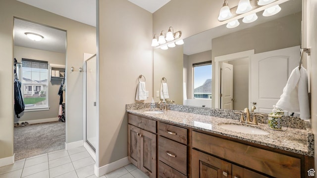 209 N Elk Ridge Dr, Elk Ridge, UT 84651 - bathroom with a stall shower, double vanity, plenty of natural light, and baseboards