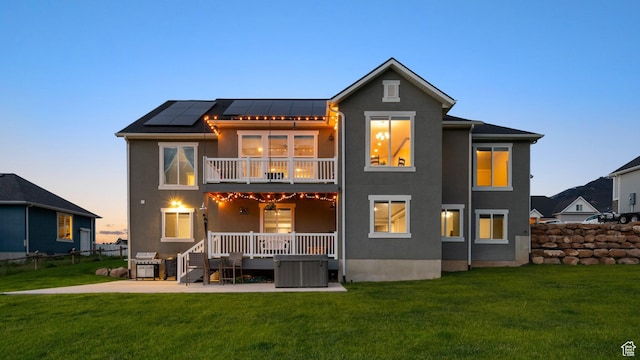 209 N Elk Ridge Dr, Elk Ridge, UT 84651 - back of house featuring a balcony, solar panels, stucco siding, a patio, and a standing seam roof
