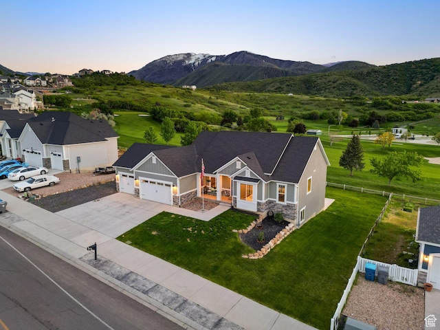 209 N Elk Ridge Dr, Elk Ridge, UT 84651 - view of front of property with an attached garage, stone siding, board and batten siding, concrete driveway, and a mountain view