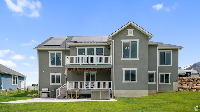 209 N Elk Ridge Dr, Elk Ridge, UT 84651 - back of property featuring stucco siding, solar panels, a balcony, and a patio area