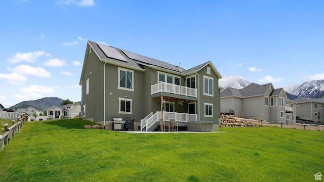 209 N Elk Ridge Dr, Elk Ridge, UT 84651 - back of house featuring a balcony, solar panels, a jacuzzi, a mountain view, and stucco siding