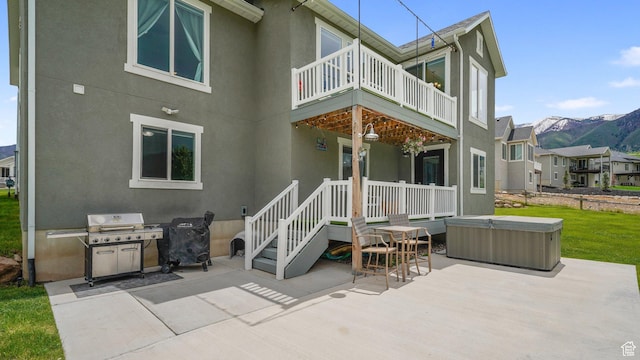 209 N Elk Ridge Dr, Elk Ridge, UT 84651 - back of house with a hot tub, a patio, a balcony, and stucco siding