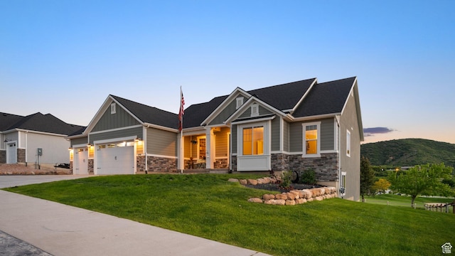 209 N Elk Ridge Dr, Elk Ridge, UT 84651 - craftsman house featuring stone siding, a front lawn, and driveway
