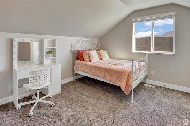 carpeted bedroom with visible vents, vaulted ceiling, and baseboards