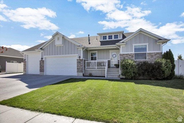 craftsman-style house with board and batten siding, a porch, a front lawn, and a garage