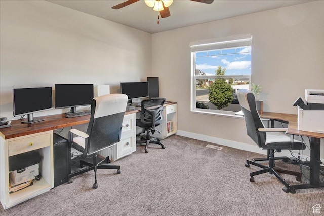 carpeted office featuring baseboards and ceiling fan